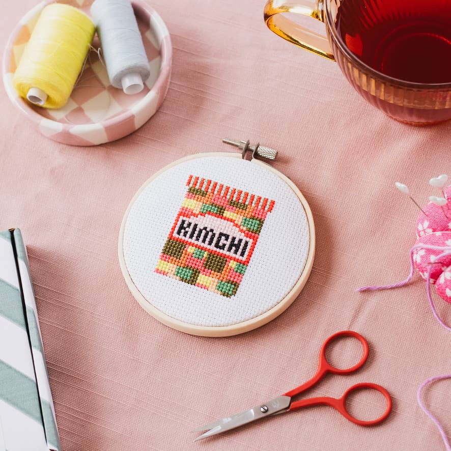 Kimchi cross stitch artwork in an 11cm wooden hoop, presented on a light background, highlighting the vibrant design.