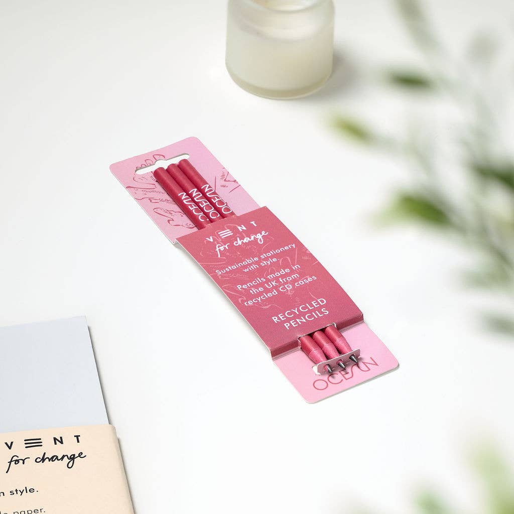 Close-up of 'OCEAN' embossed design on recycled coral pink pencil