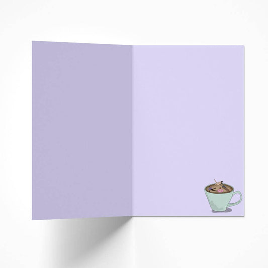 Inside view of the coffee lover birthday card, showing a subtle lilac hue and a small matching illustration of women bathing in coffee in the bottom right corner.