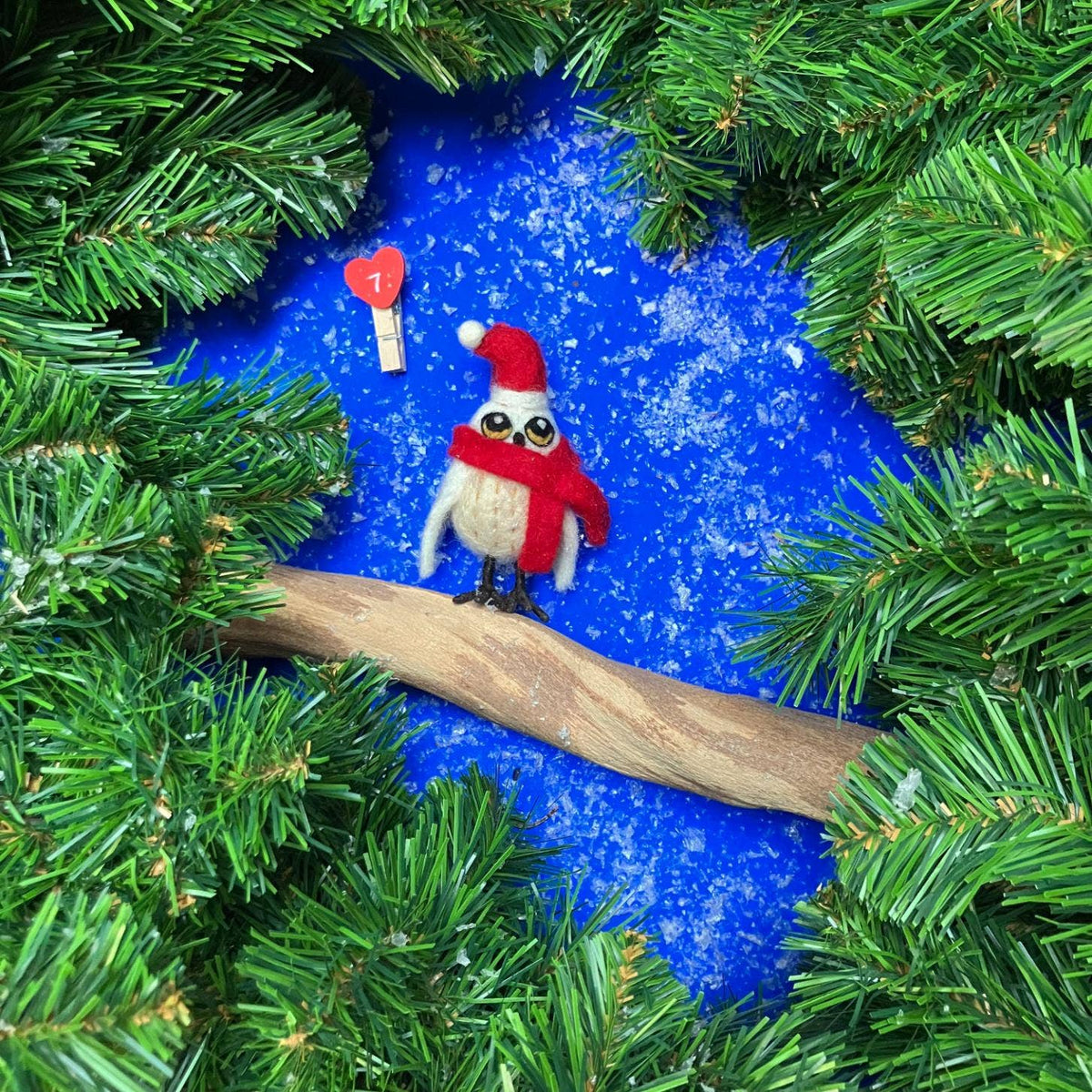 Plastic-free felt snowy owl holiday ornament wearing festive Santa hat