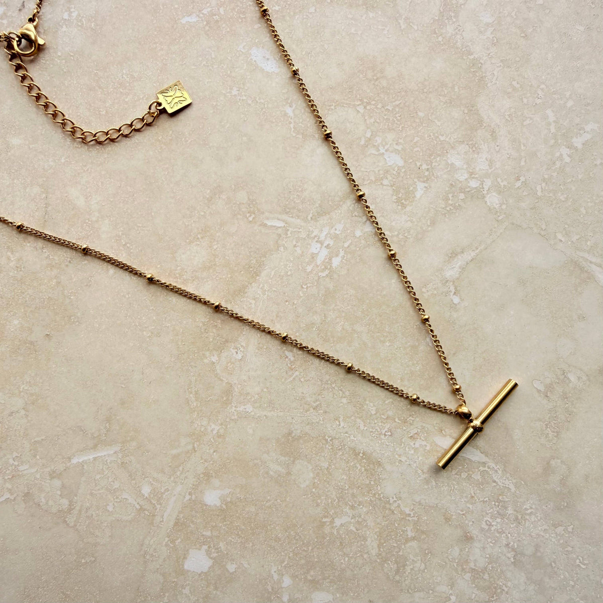 Everyday gold bar necklace laid flat showing chain detail