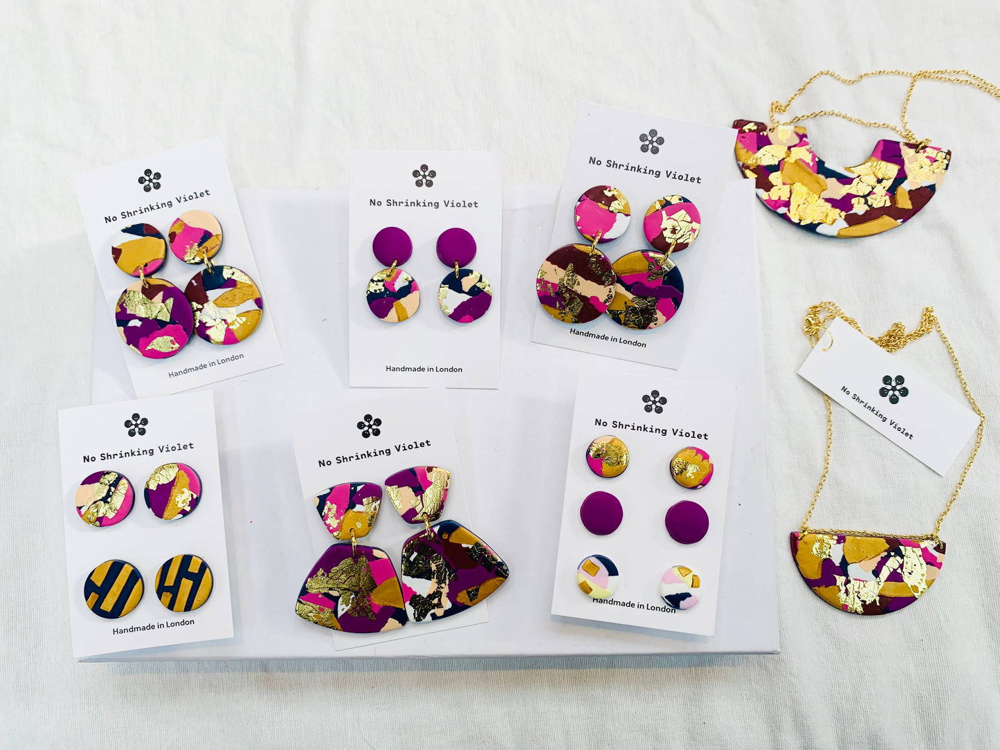 Model wearing Winter Sunrise polymer clay stud earrings, showcasing their vibrant colours.