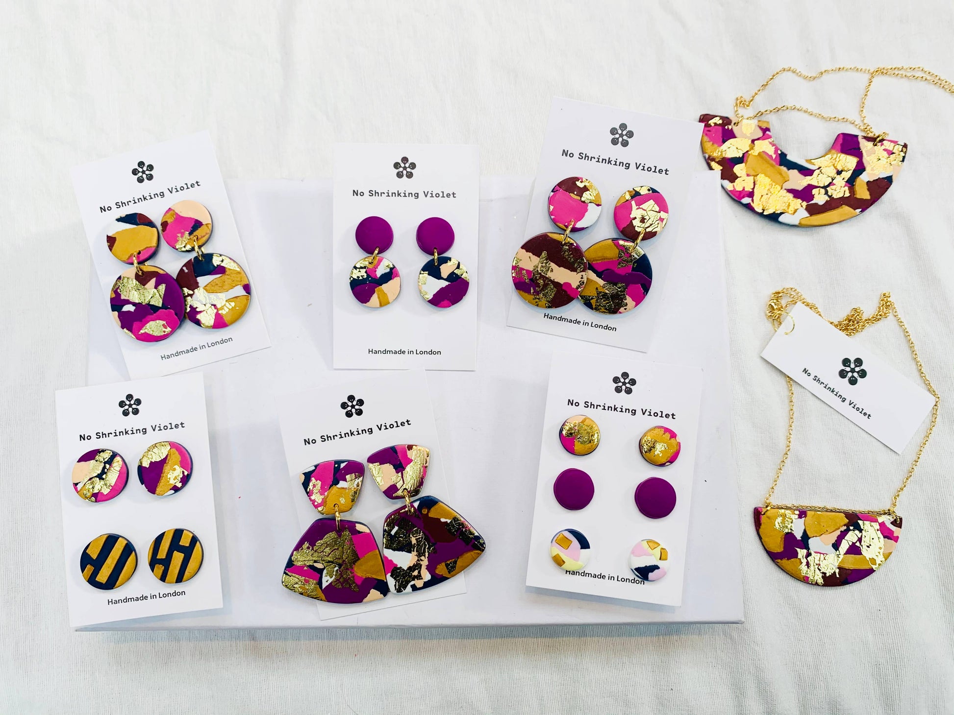 Model wearing Winter Sunrise polymer clay stud earrings, showcasing their vibrant colours.