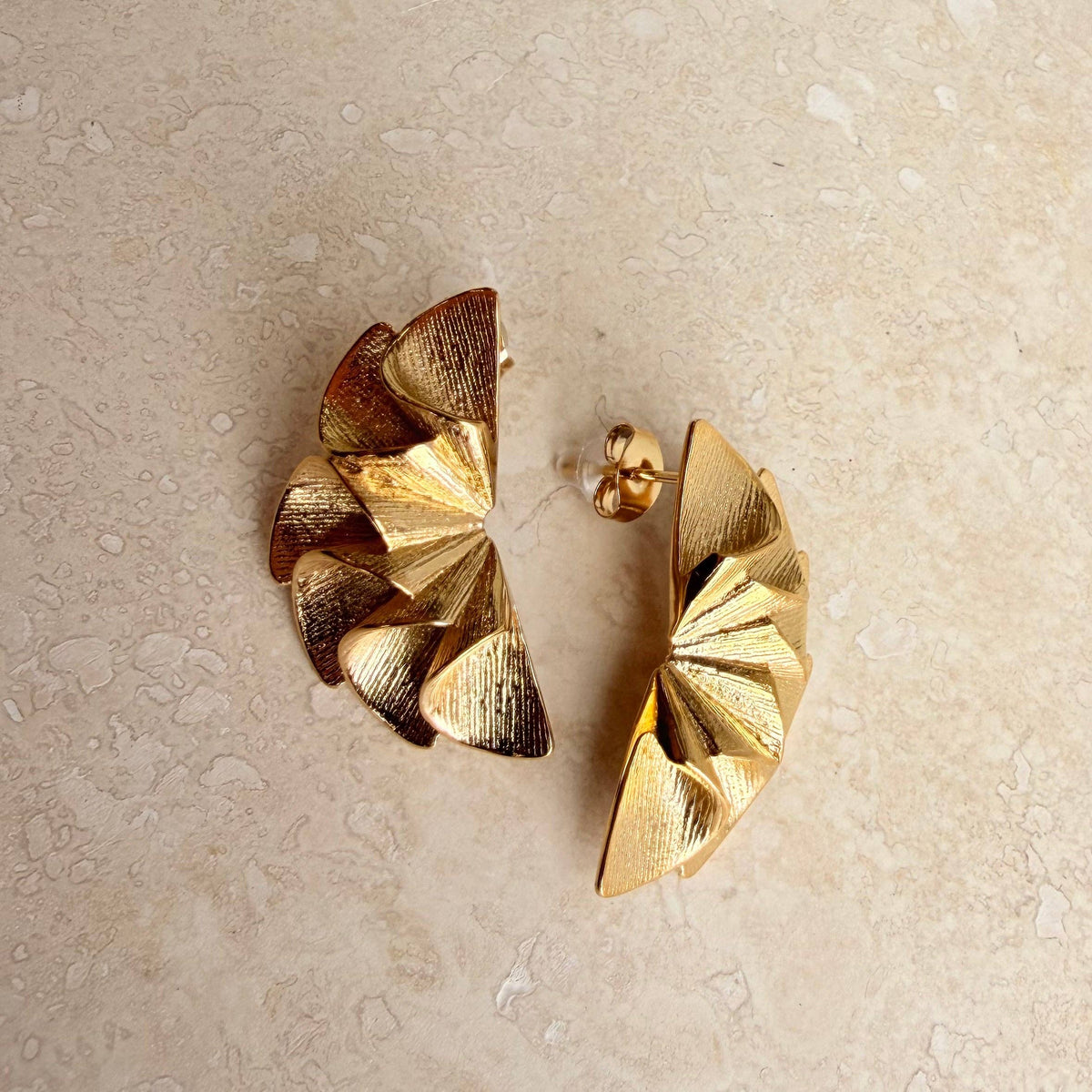 Textured ruffled semi-circle earrings on a model