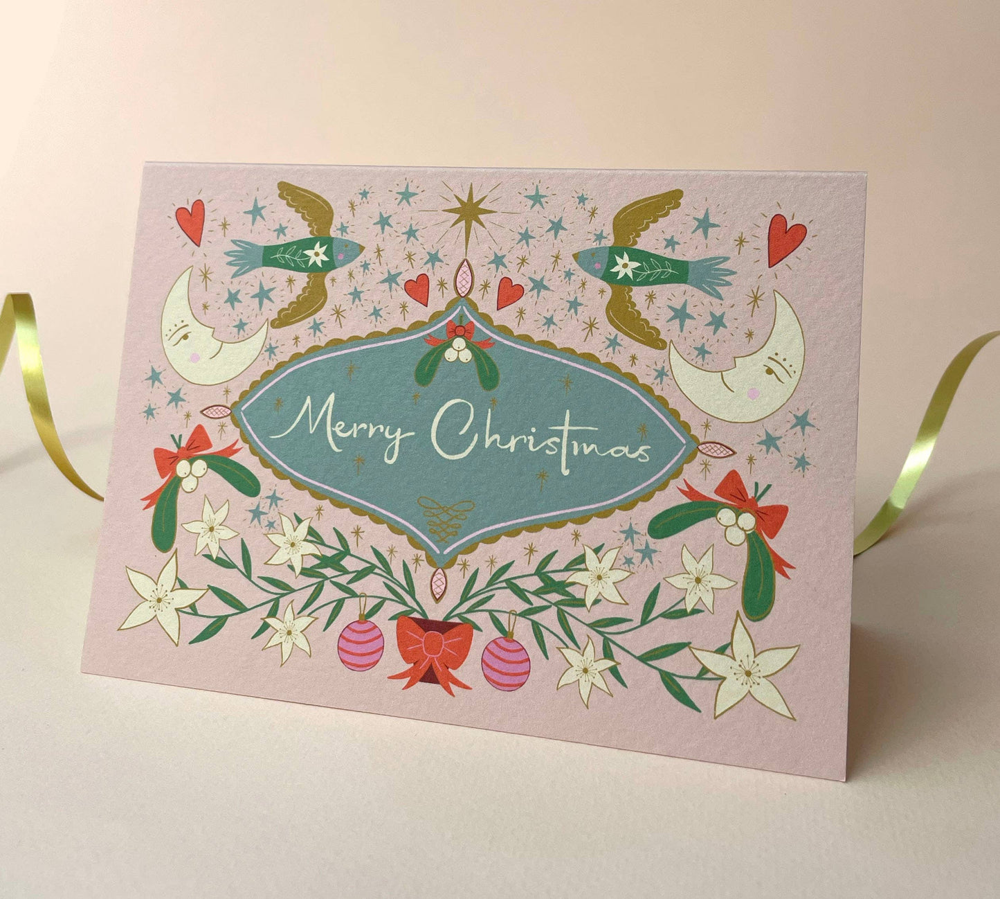 Pastel Christmas card with red envelope and compostable packaging