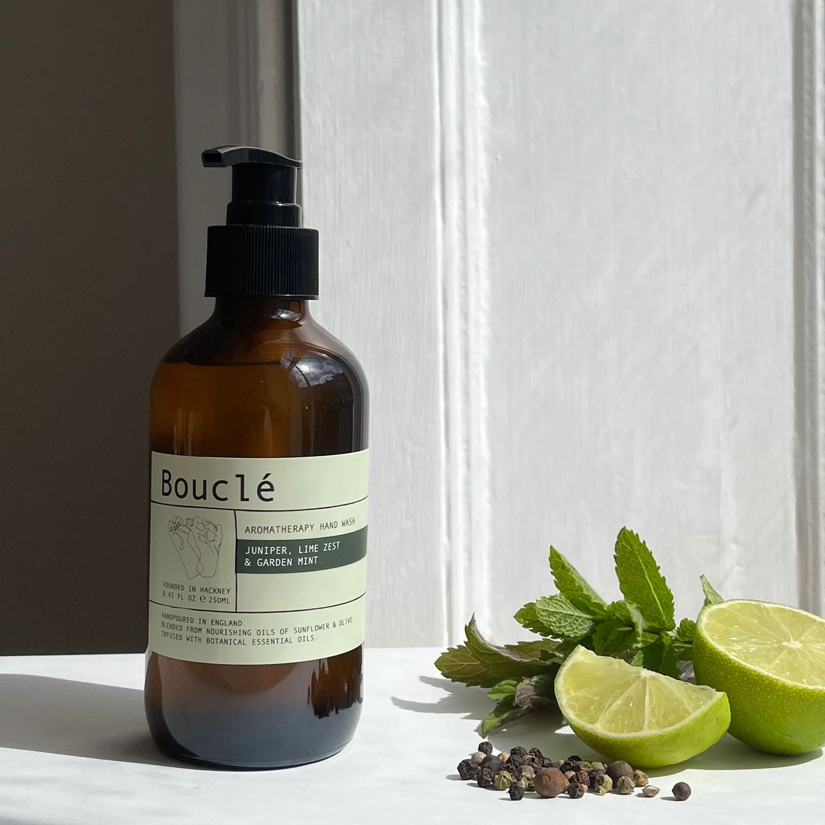 Juniper, Lime Zest and Garden Mint Essential Oil Hand Wash in amber glass bottle