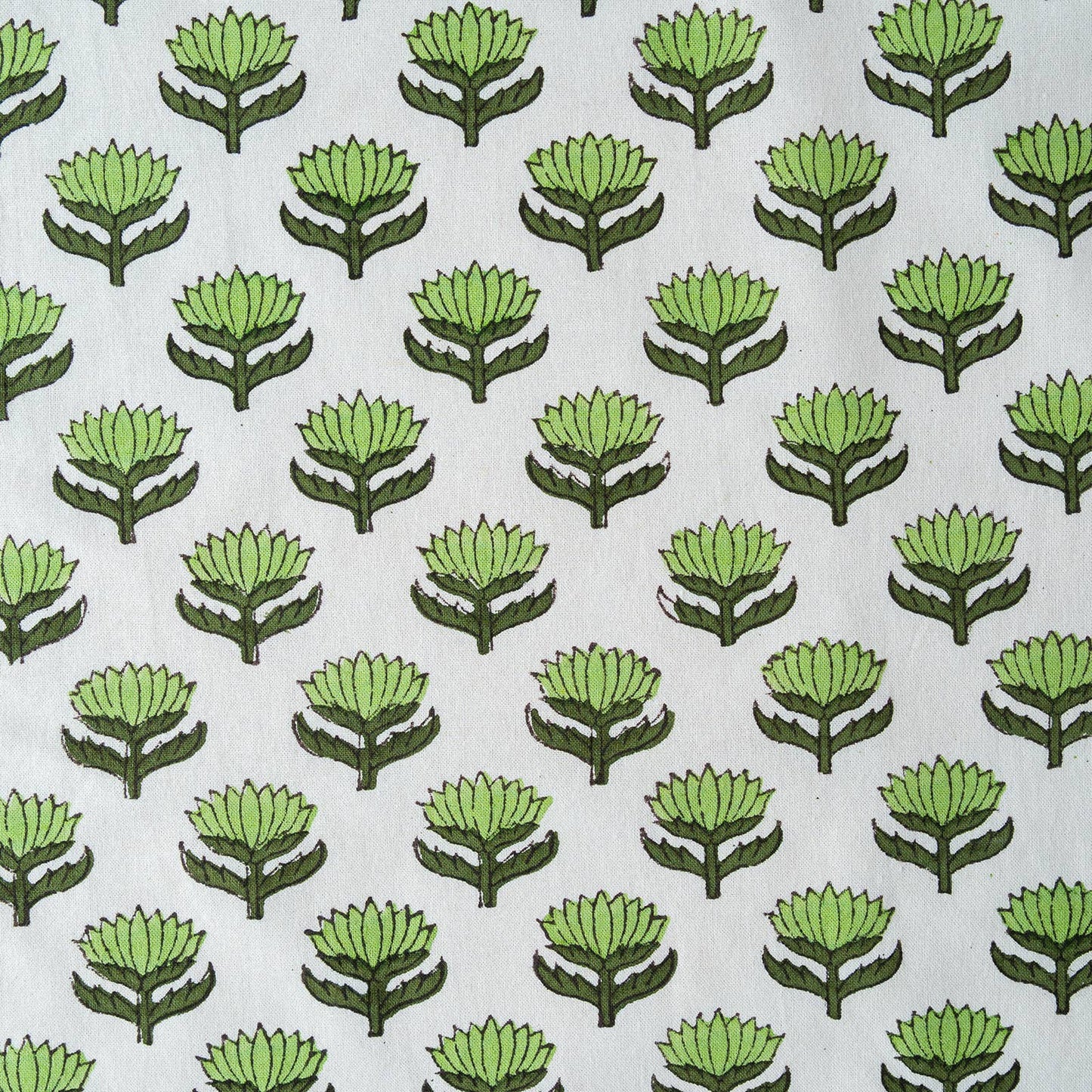 Close up of hand-block printed green lotus flower pattern on cotton napkin