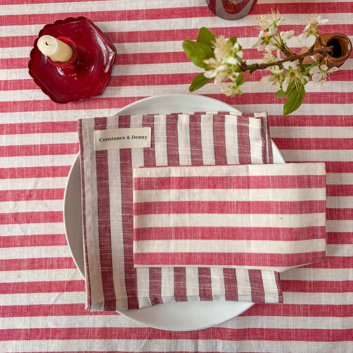 Close up of 100% cotton woven stripe napkins in poppy red and natural