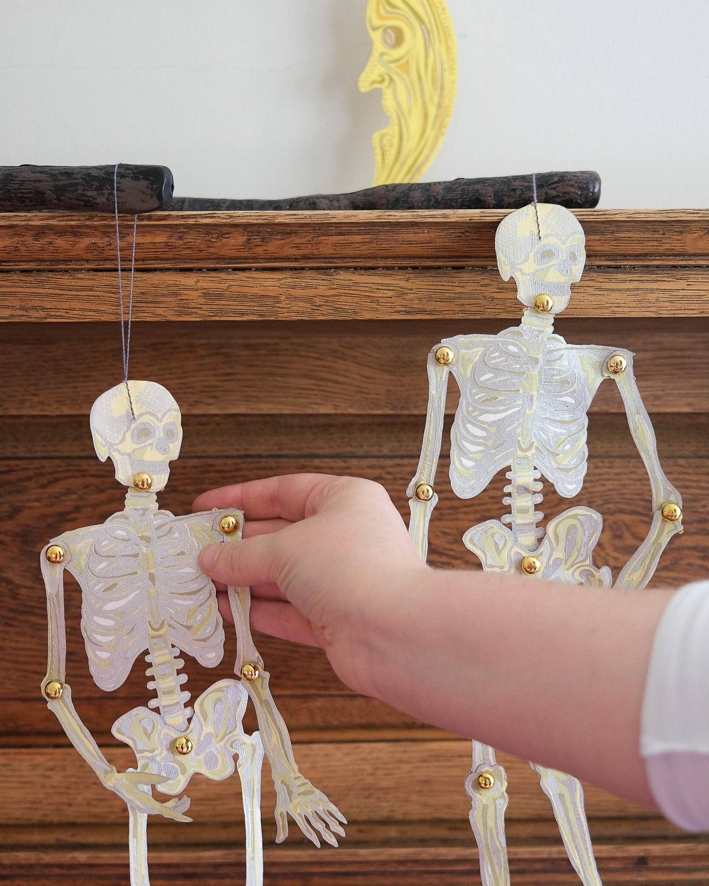 Pair of playful dancing skeletons paper decorations, perfect for quirky or Halloween home styling.