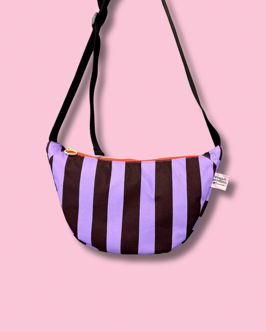 Adjustable strap details on the striped waxed canvas sling bag