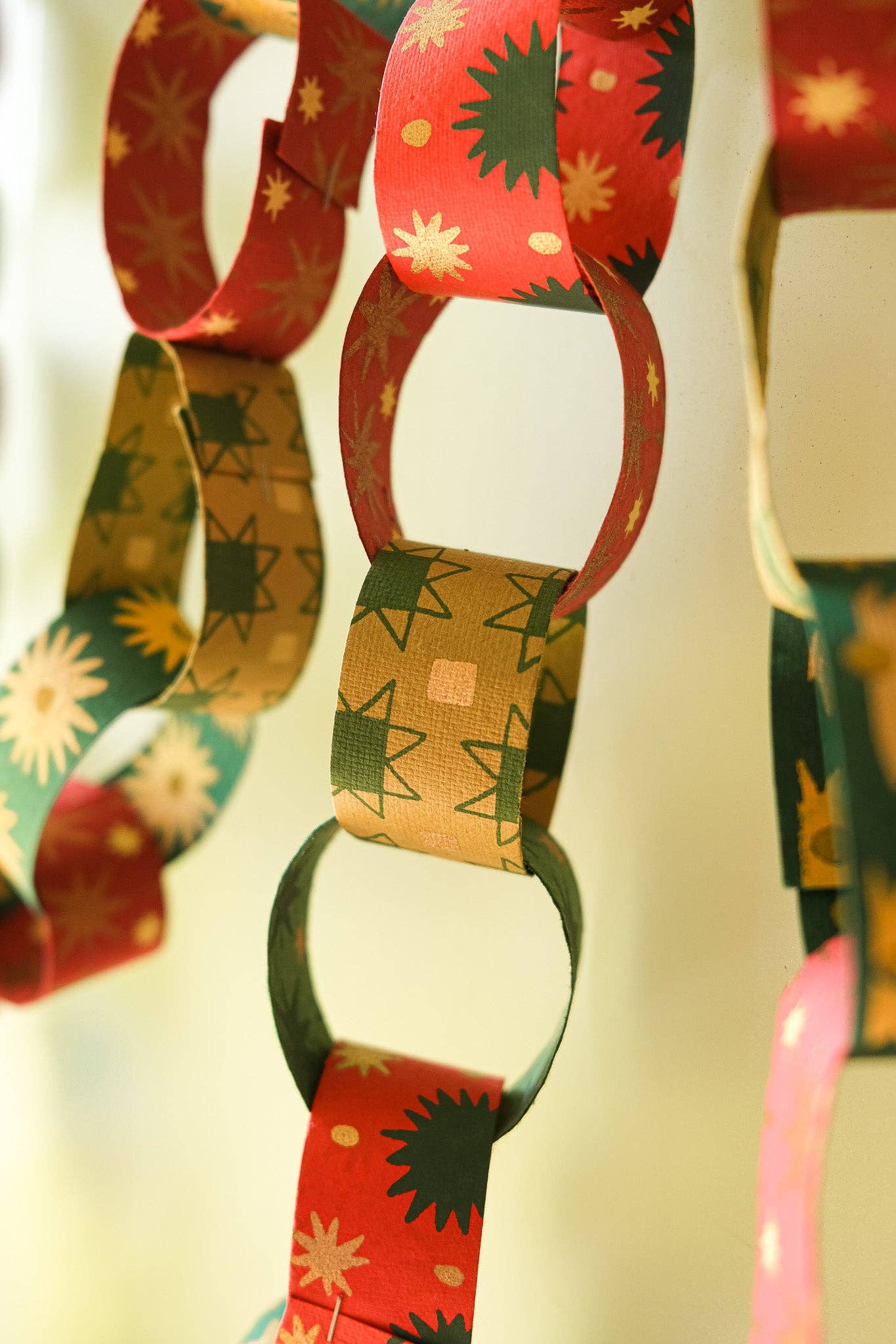 Recycled festive paper chain strips, hand-printed double-sided, eco-friendly decoration kit.