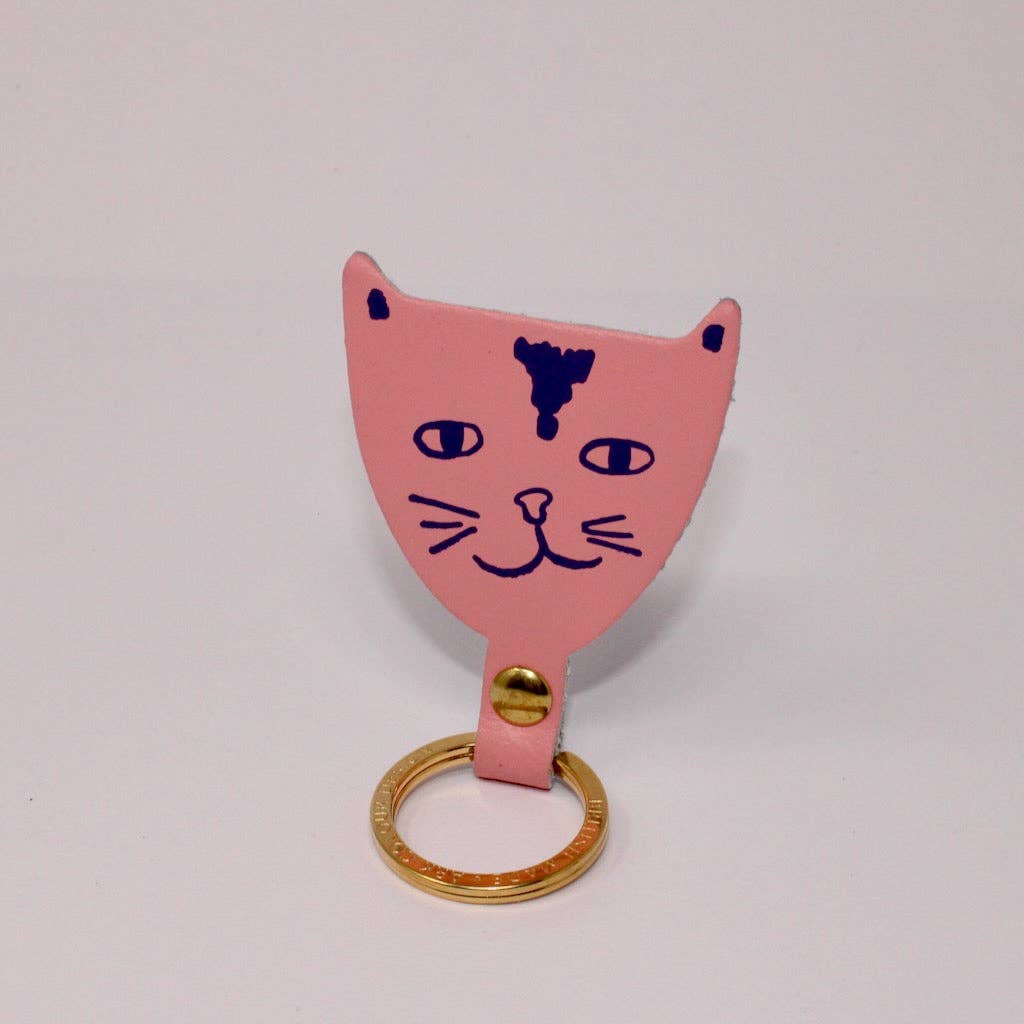Tan leather cat head key fob standing upright
