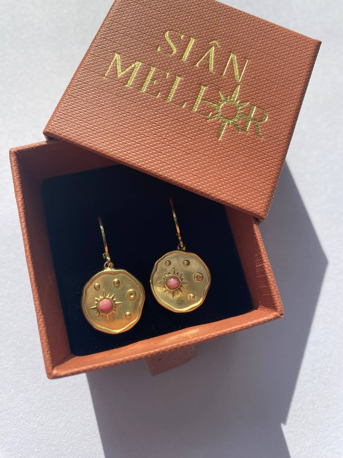 Gold celestial disk huggie earrings in sustainably sourced gift box