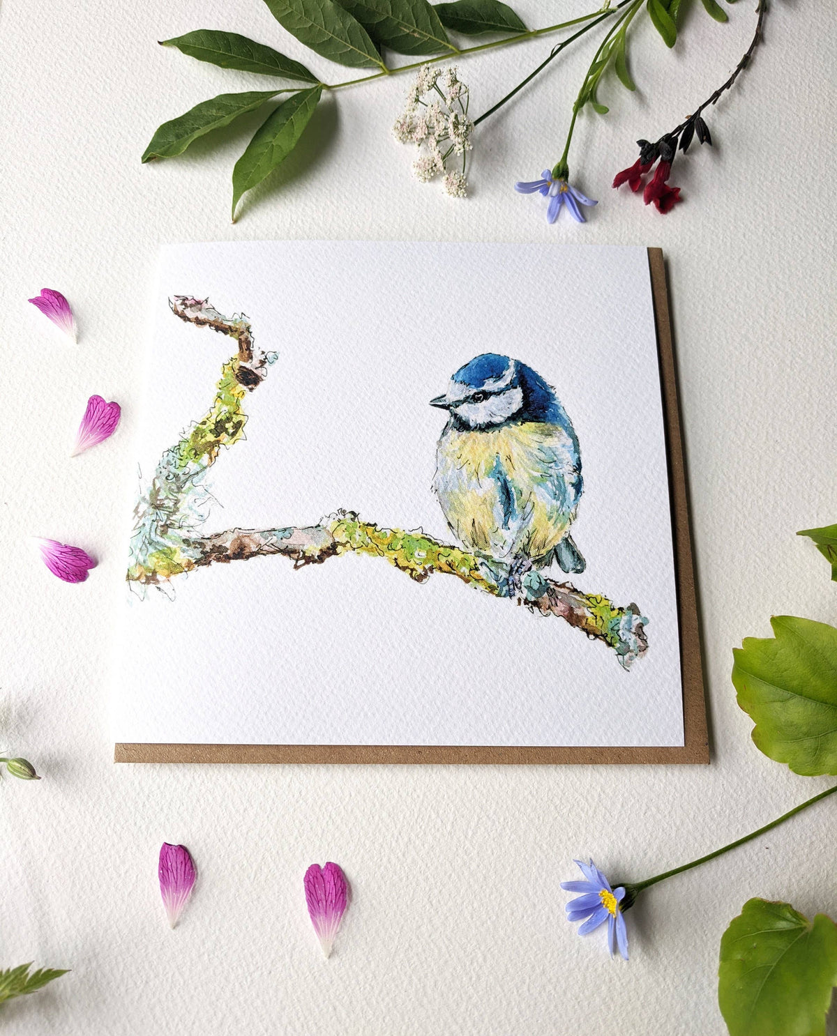 Close up of textured watercolour paper on blue tit card