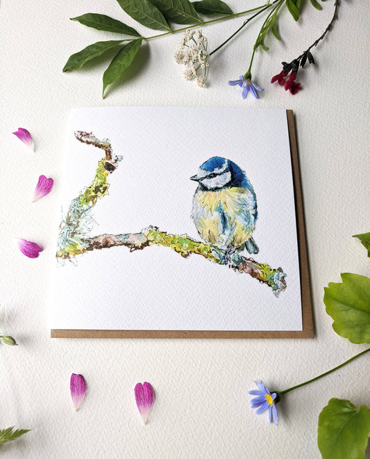Close up of textured watercolour paper on blue tit card