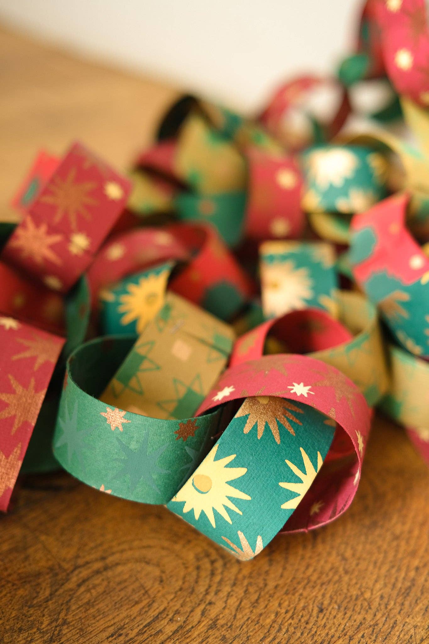 Recycled festive paper chain strips, hand-printed double-sided, eco-friendly decoration kit.