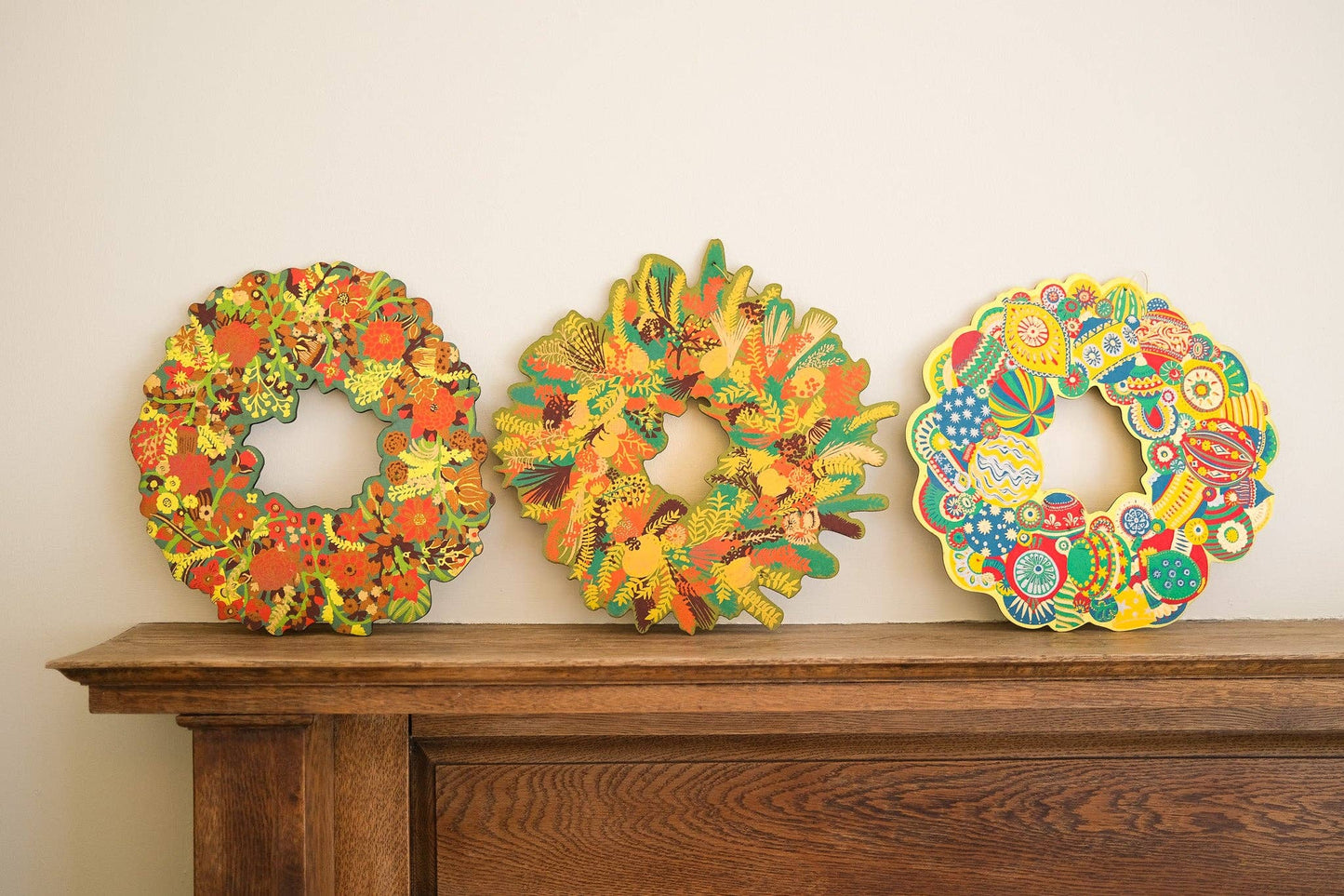 Hand-printed cotton board wreath with winter blooms, sustainable Christmas ornament