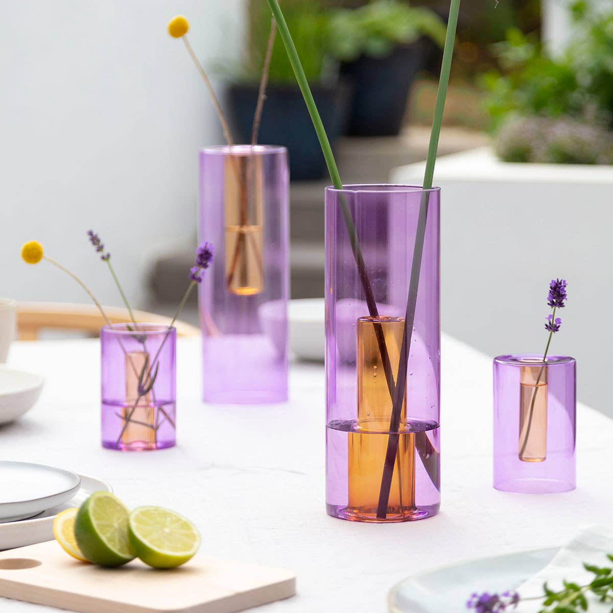 Reversible glass vase purple and orange used as a single stem bud vase
