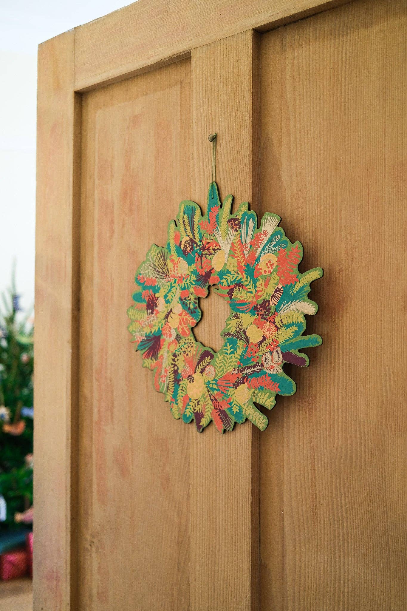 Hand-printed cotton board wreath with winter blooms, sustainable Christmas ornament