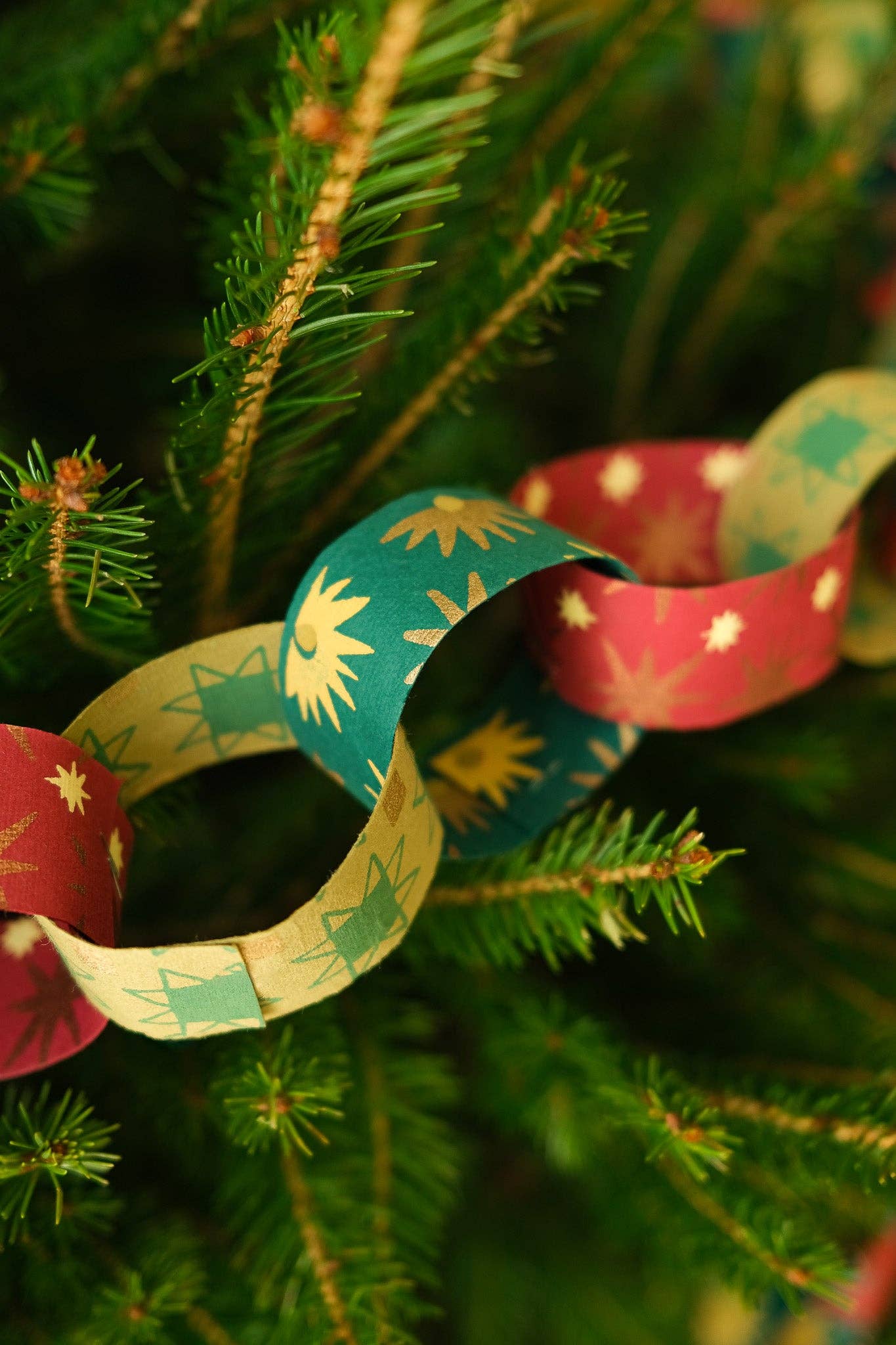 Recycled festive paper chain strips, hand-printed double-sided, eco-friendly decoration kit.