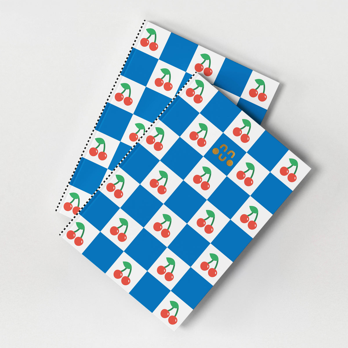 Cherry patterned A5 notebook with gold foil detail and blue chequered background