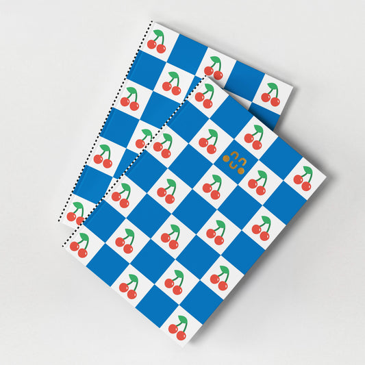 Cherry patterned A5 notebook with gold foil detail and blue chequered background