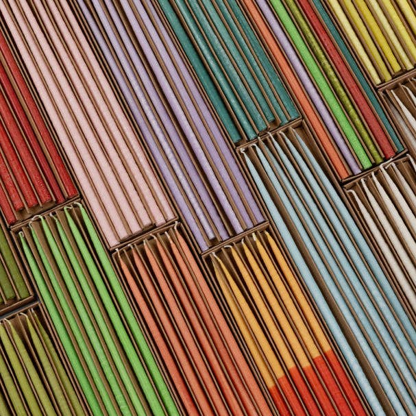 Close up of saffron and rust hand dipped taper candles