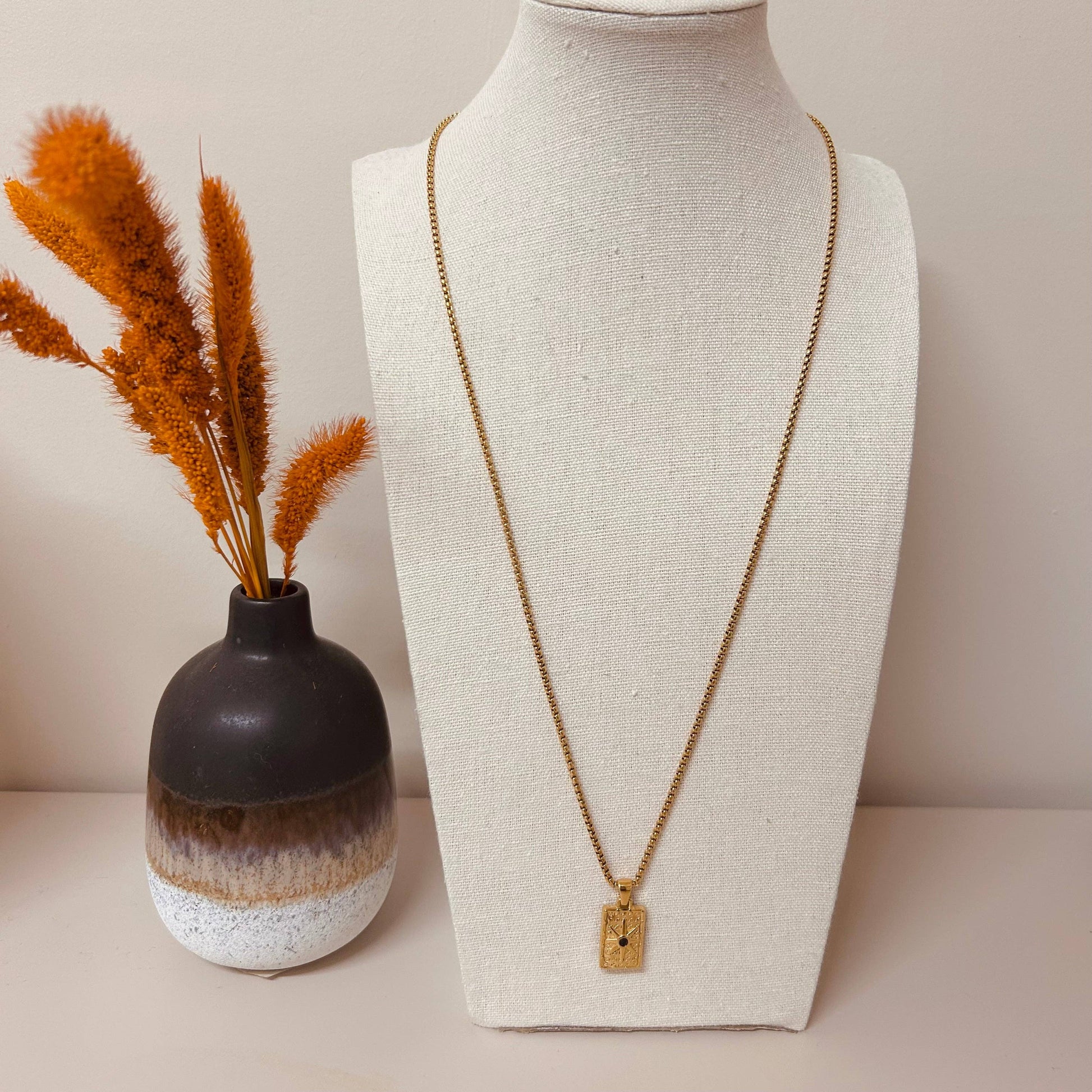 Little Nell Long Noir Rectangle Necklace with gold pendant and black star detail on adjustable 60cm chain.