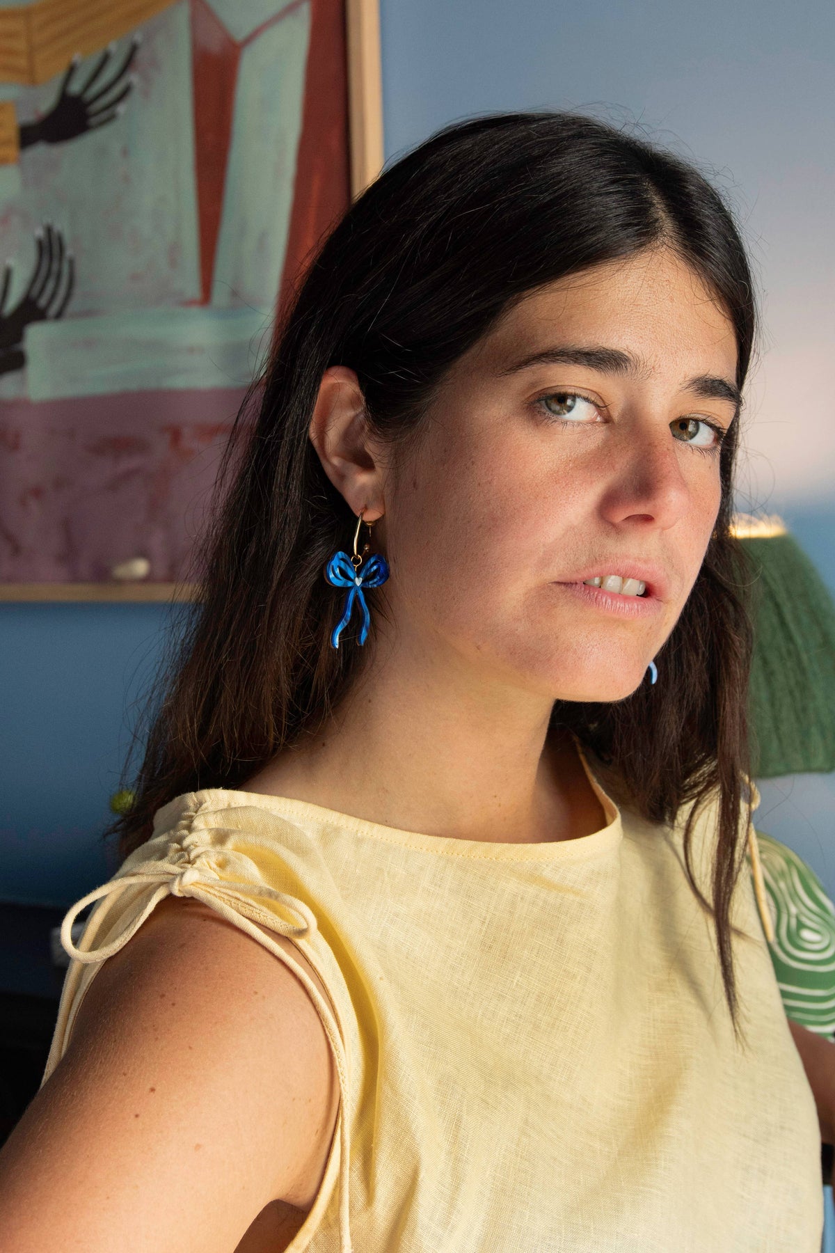 Model wearing 6.5cm drop statement bow hoop earrings