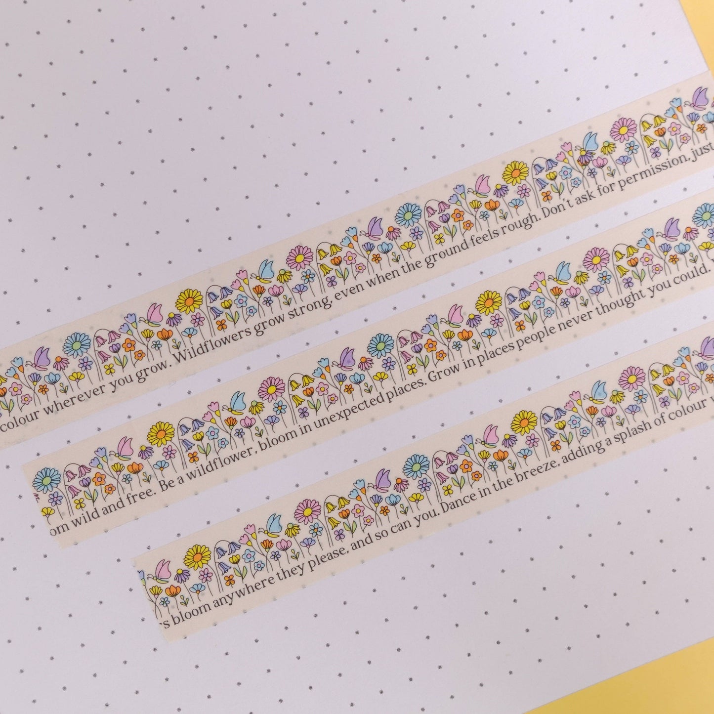 Close-up of 'Be a Wildflower' Washi Tape showing positive quotes and a delicate wildflower design on a cream background.
