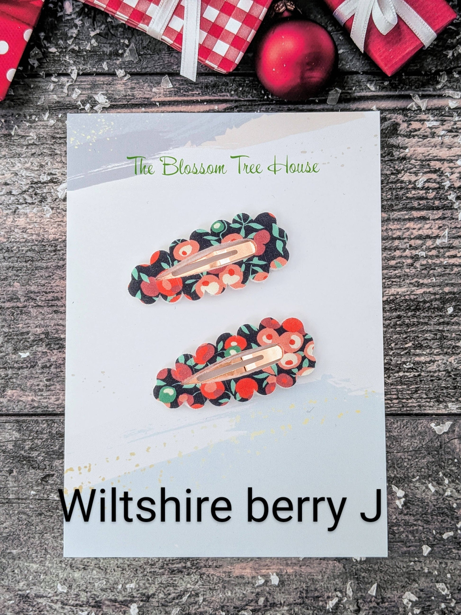 Two hair clips with a floral design on a card labeled 'Wiltshire berry J' from 'The Blossom Tree House'.