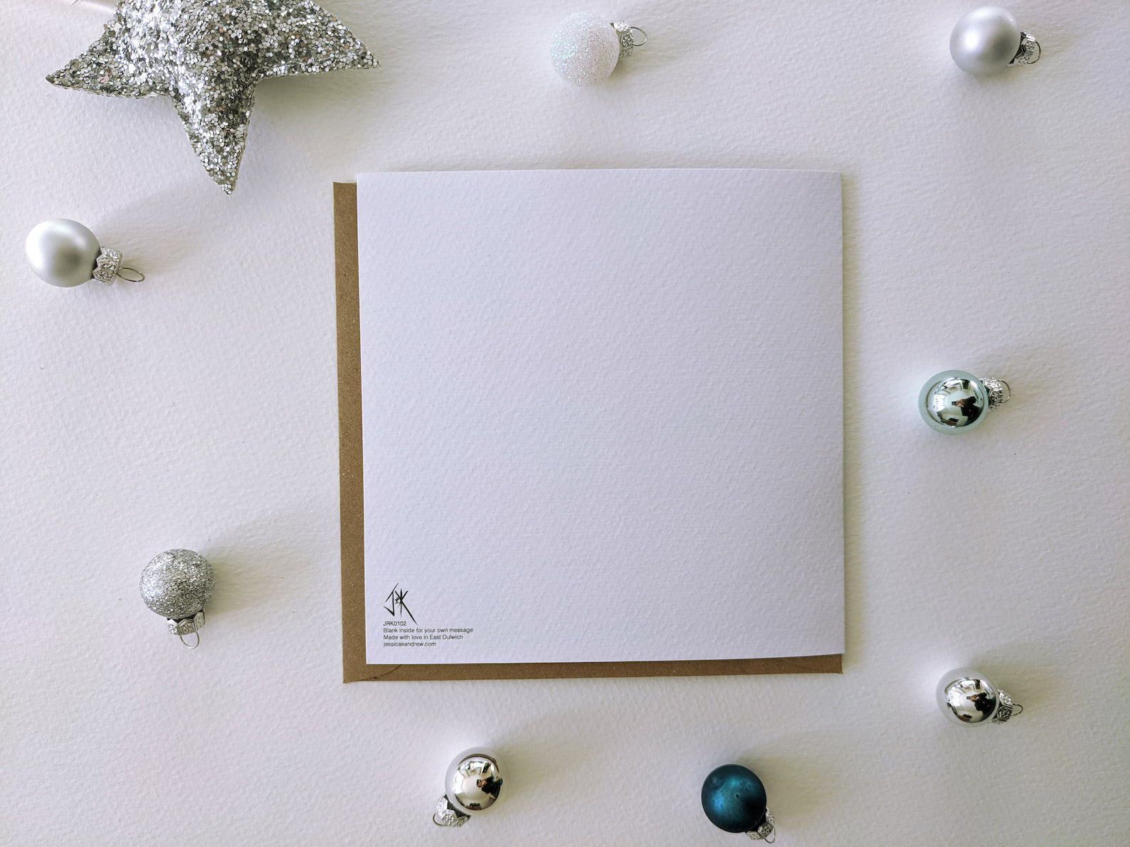 Mistletoe & Swine Christmas card with brown kraft envelope, showcasing its eco-friendly presentation.