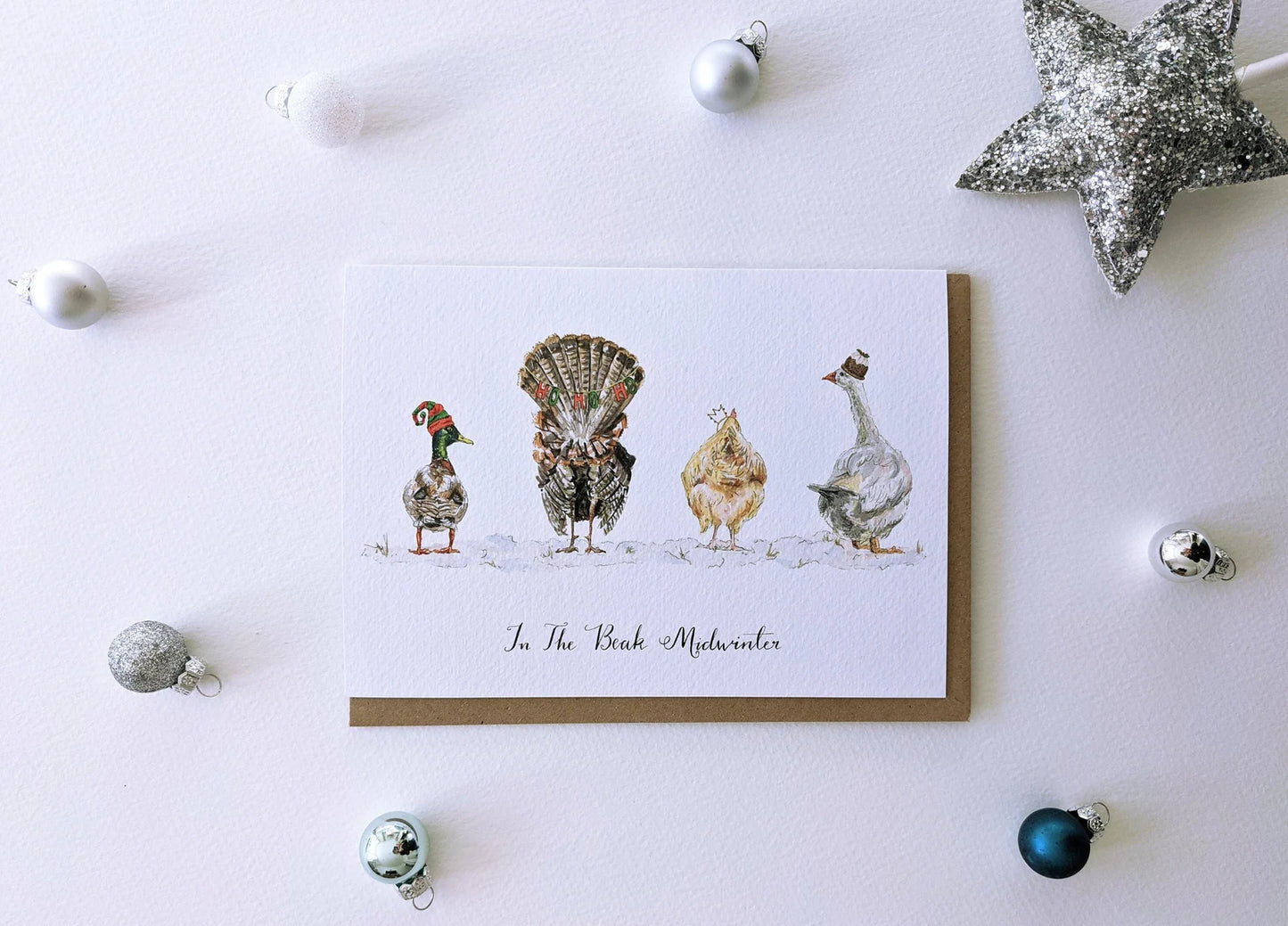 Close-up of Jessica Kendrew's 'In the Beak Mid-winter' Christmas card, textured paper detail and cheeky bird design