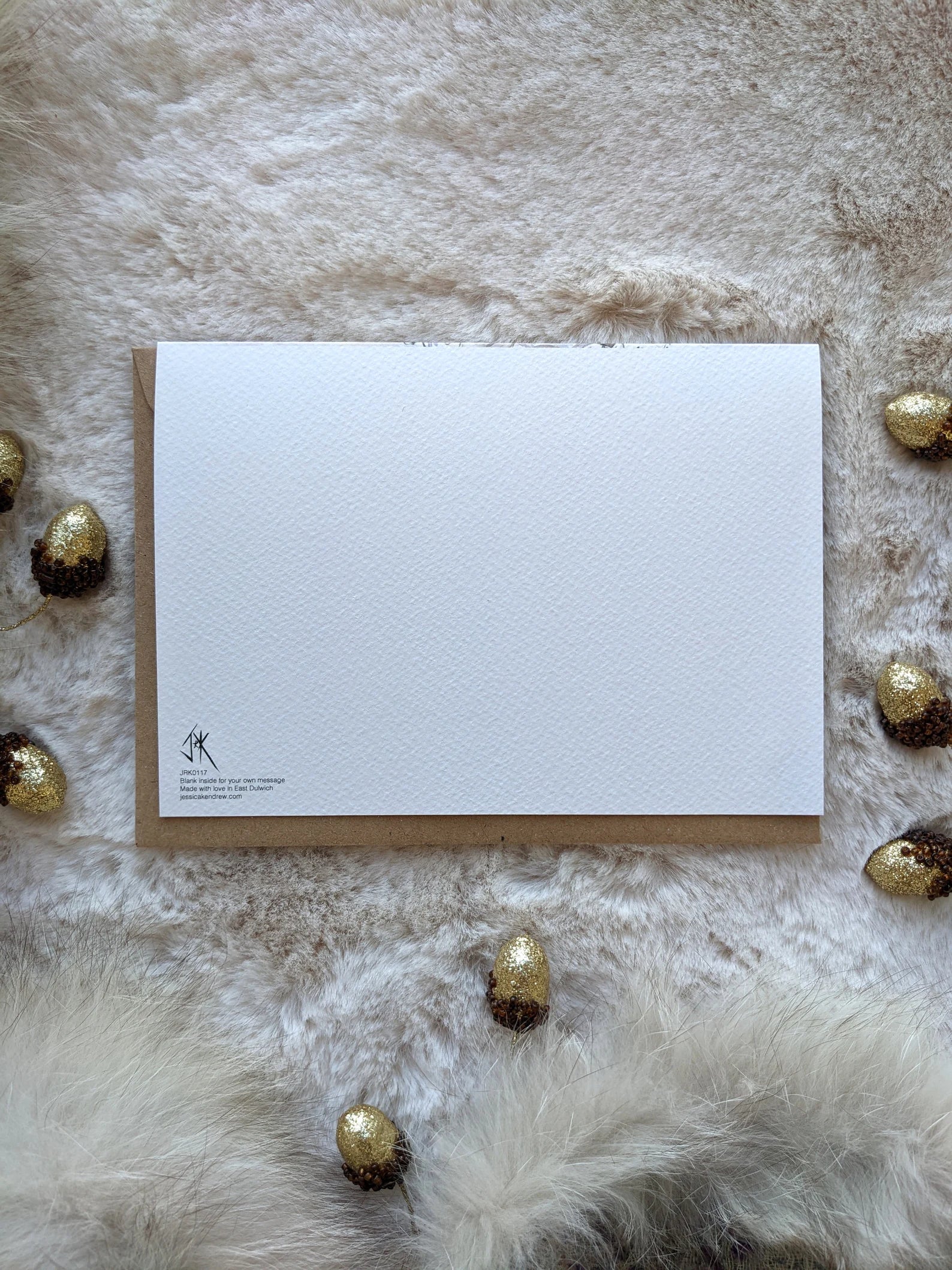 Close-up of Jessica Kendrew Christmas card with brown kraft envelope