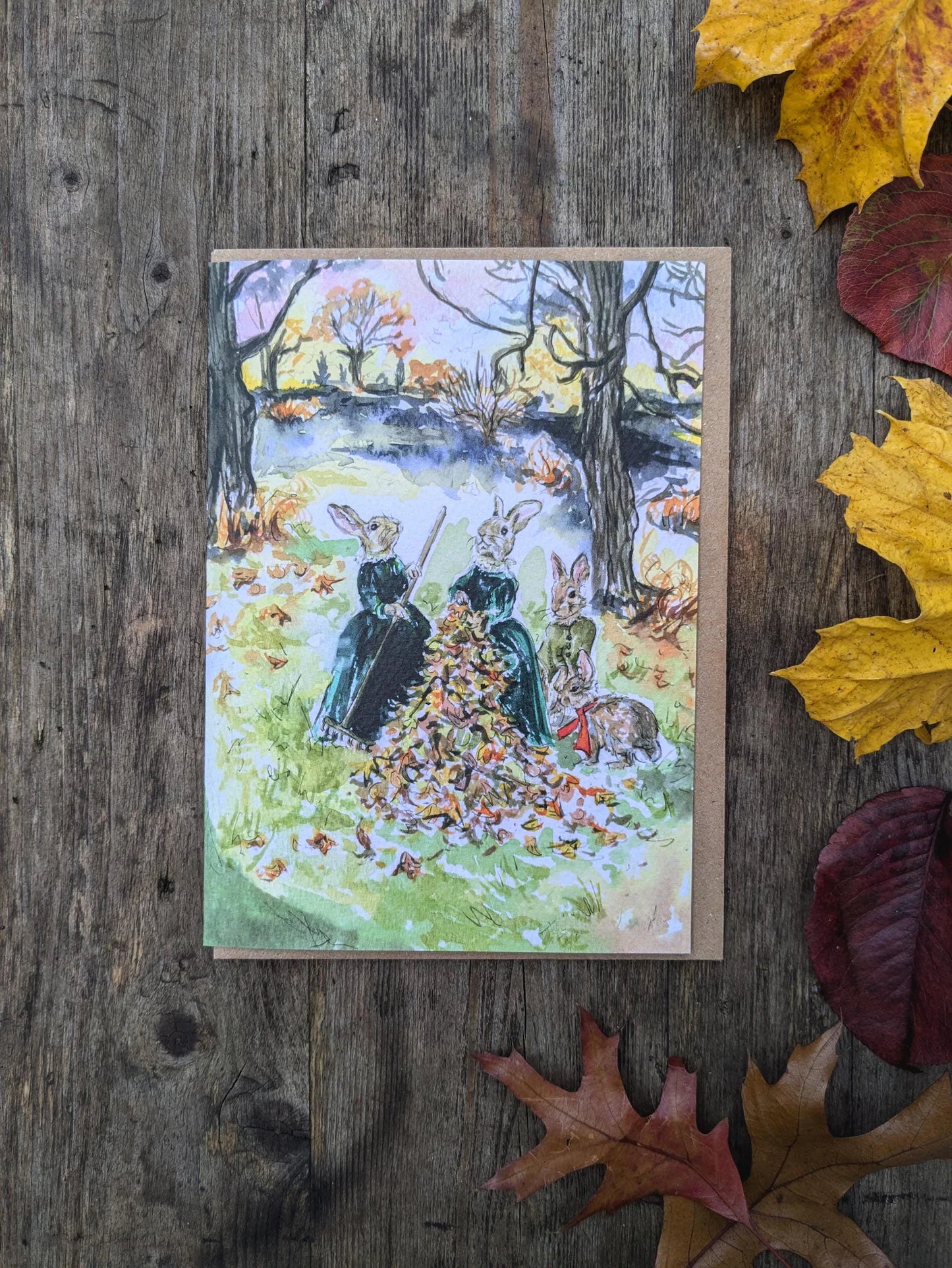 Woodland Rabbits Raking Autumn Leaves Greeting Card by Jessica Kendrew