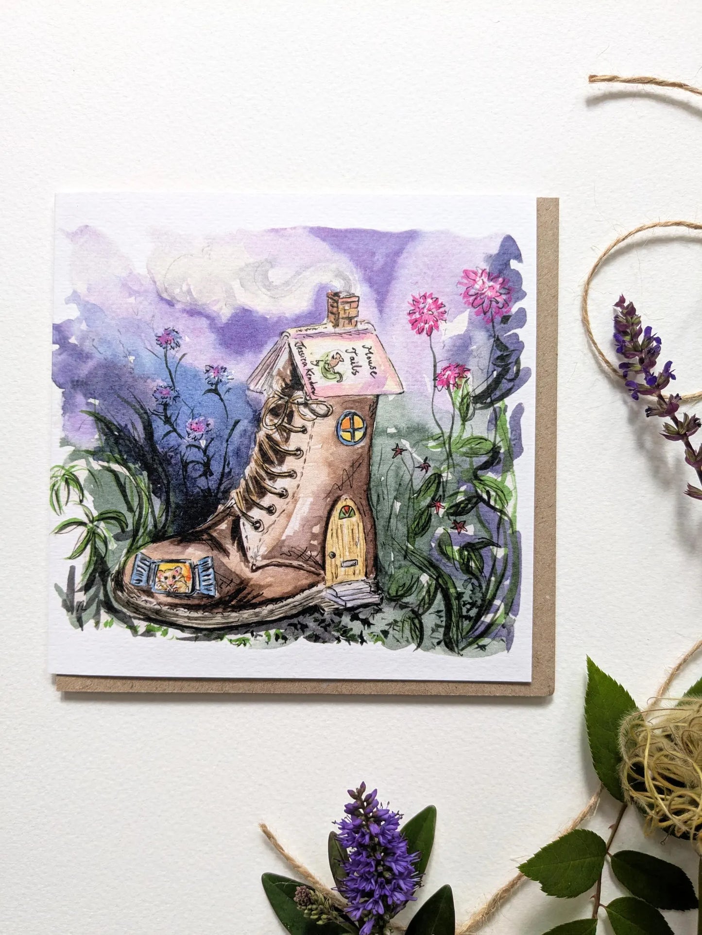 Whimsical harvest mouse in a worn leather Dr. Martens boot on a greeting card by British artist Jessica Kendrew