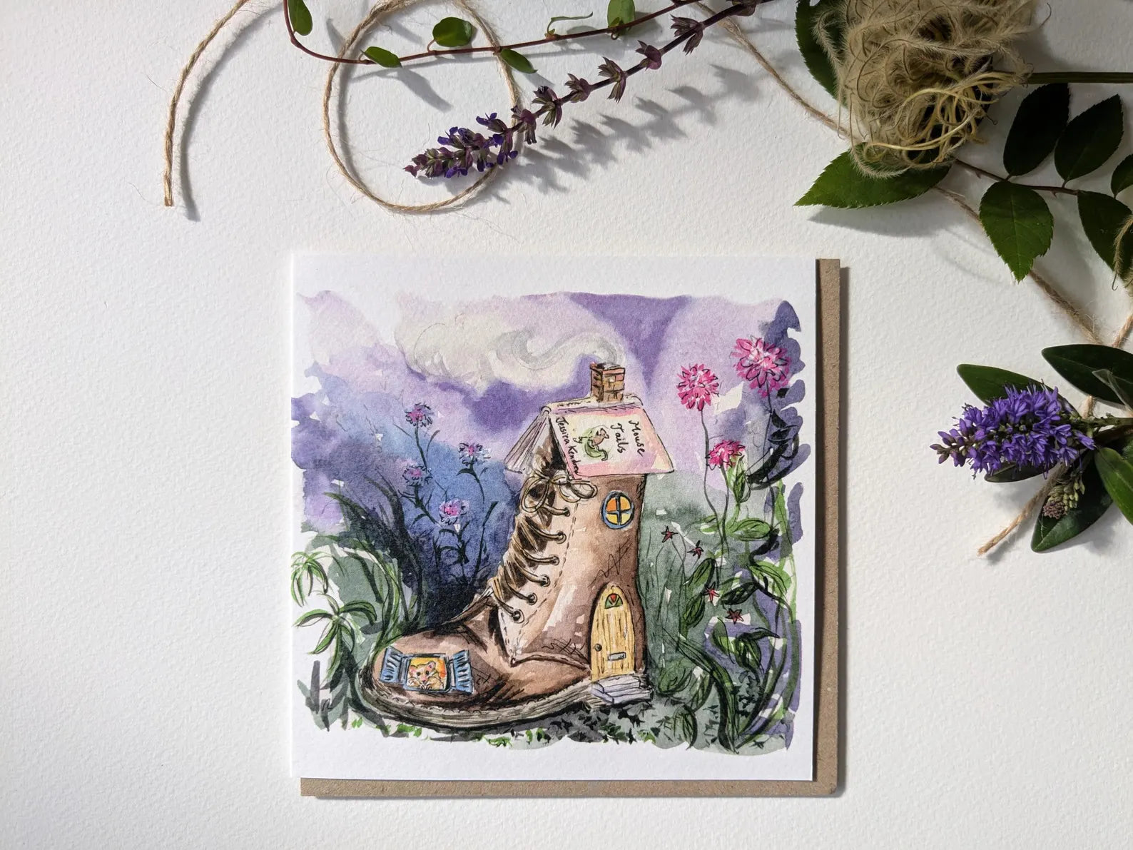 Close-up of the whimsical harvest mouse in a worn leather Dr. Martens boot on a greeting card by Jessica Kendrew