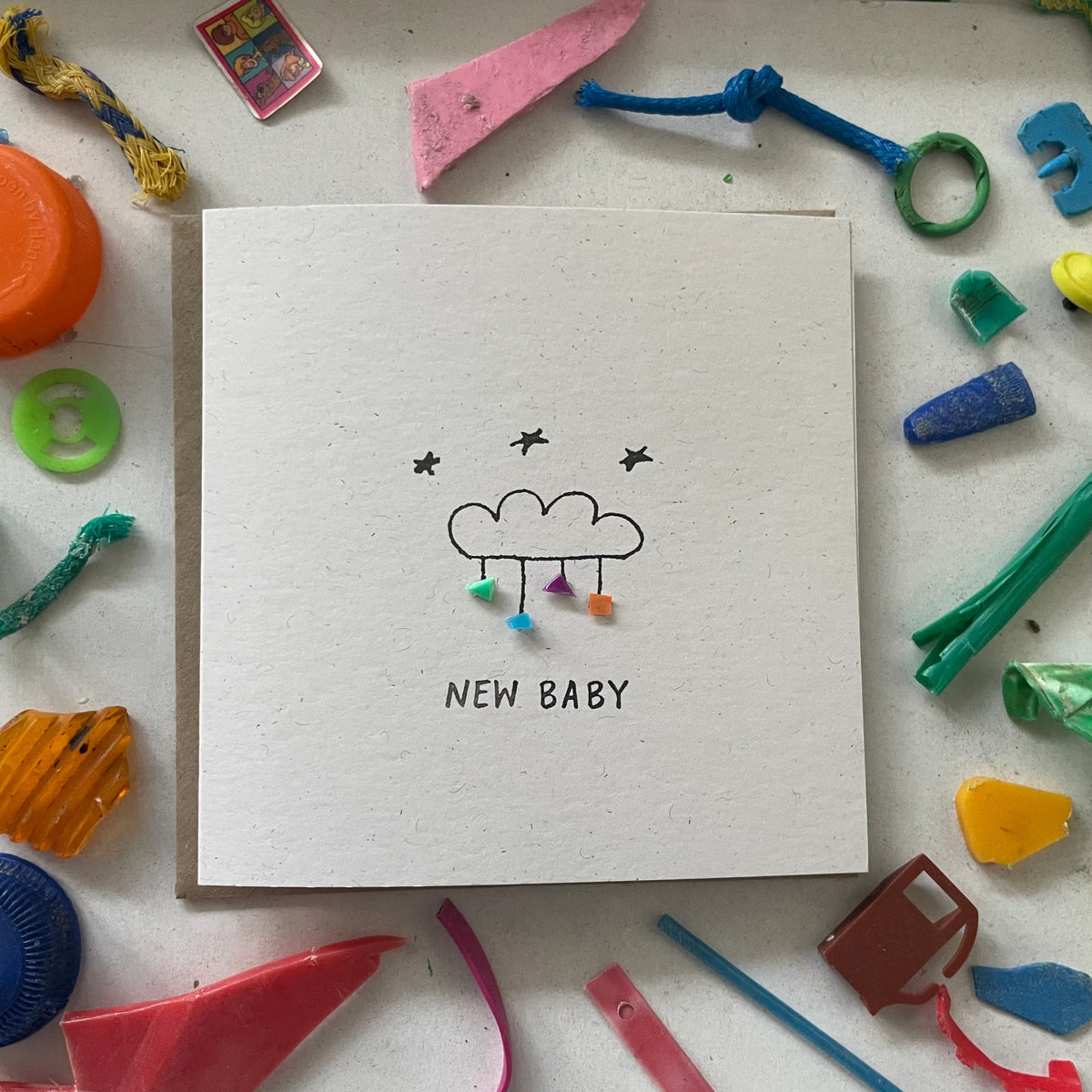 New Baby greeting card with cloud, stars, and unique microplastic art. Eco-friendly recycled card.
