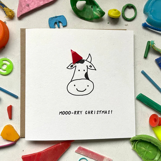 Washed UP cards sustainably made in the UK. Featuring a black and white cow with micro plastic party hat, salvaged from the Thames River.