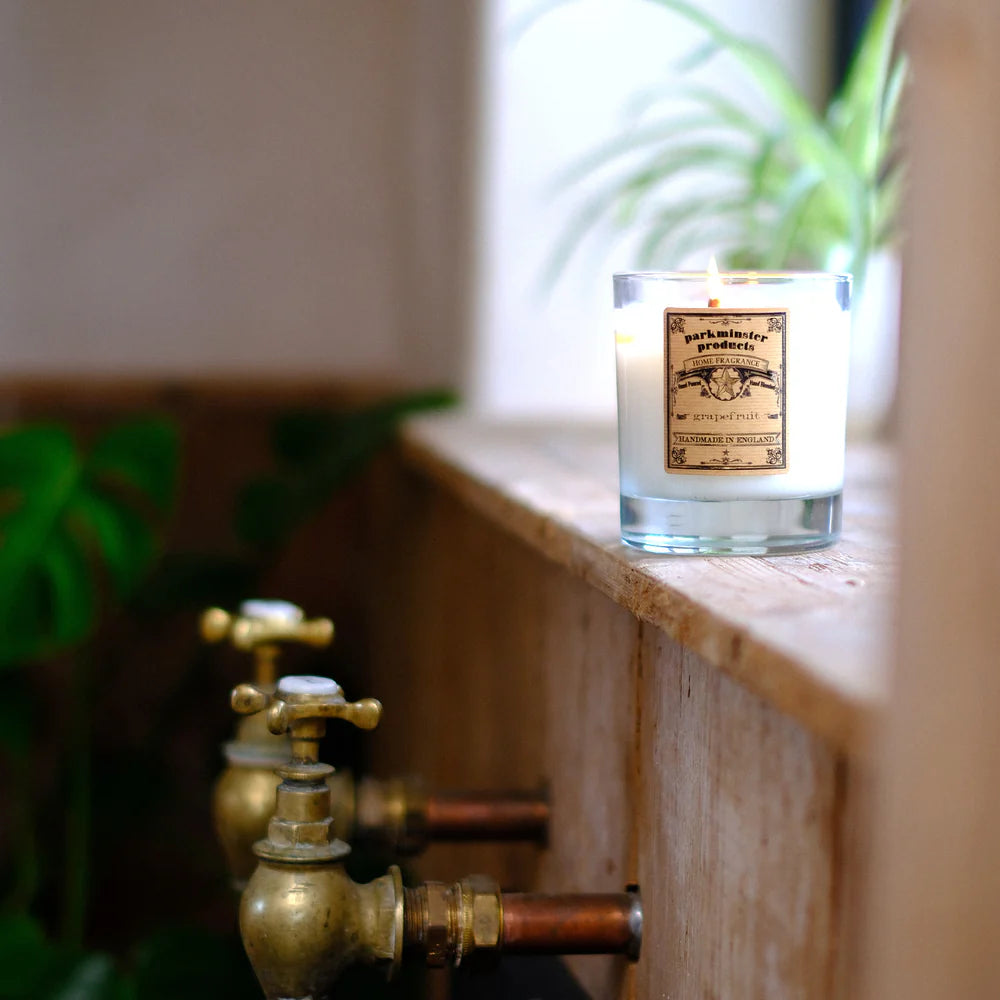 Parkminster Grapefruit scented soy candle in recyclable glass container, handmade with natural vegan wax and labelled with a fresh, fruity, and bittersweet fragrance profile.