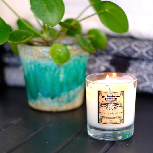 Parkminster Grapefruit scented soy candle in recyclable glass container, handmade with natural vegan wax and labelled with a fresh, fruity, and bittersweet fragrance profile.