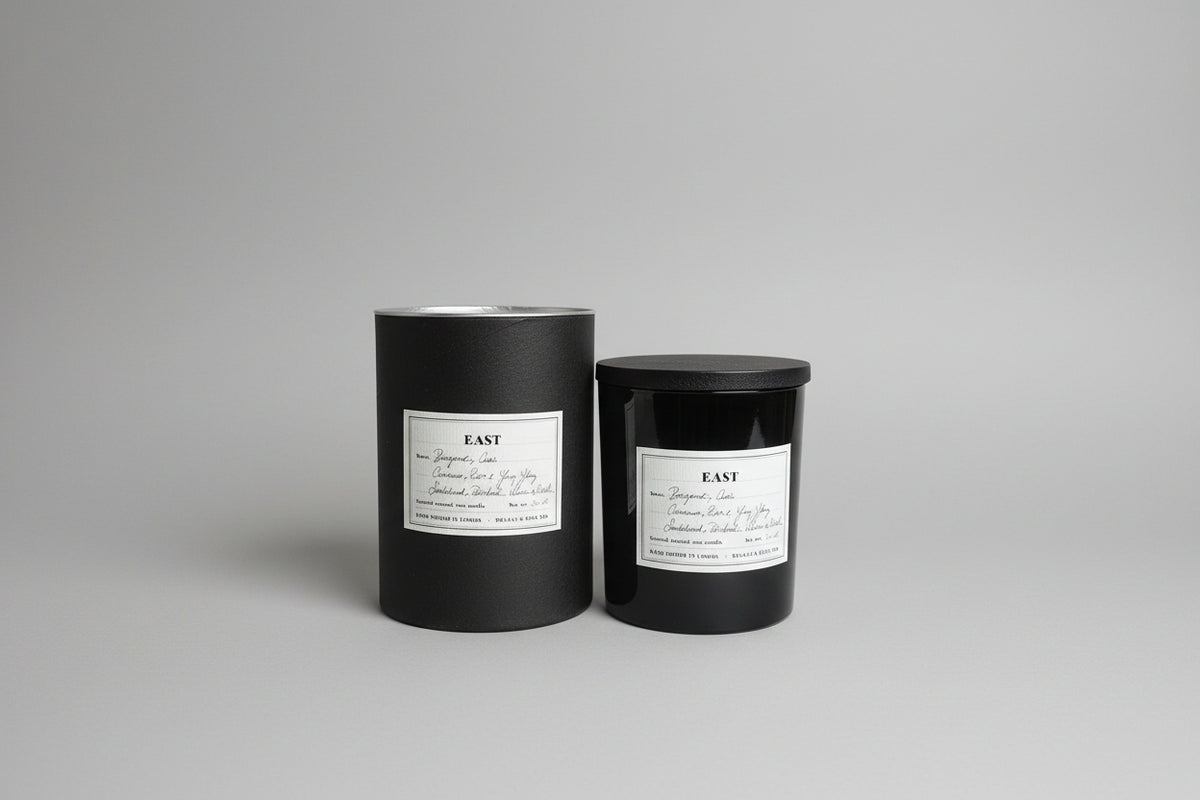 Sustainable East soy candle with wooden lid lid on a neutral background