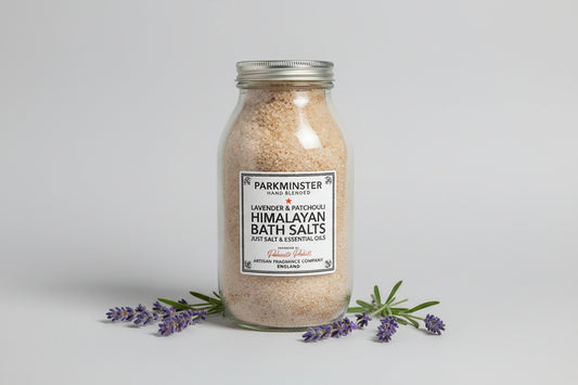 Glass jar of Lavender & Rosemary Himalayan Bath Salts and botanical essential oils.
