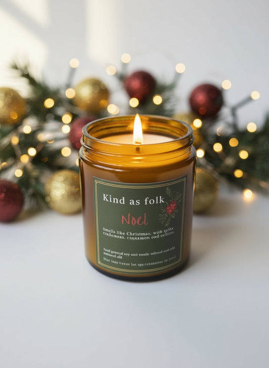 Close-up of Noel Soy Candle, showing soy wax and wick in an eco-friendly amber jar