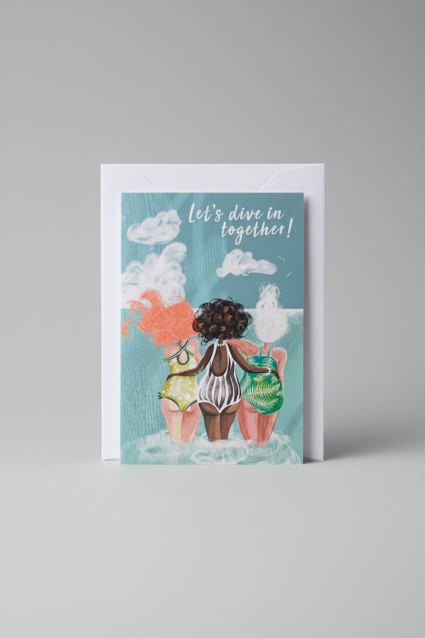 Eco-friendly Sea Sisters wild swimming card with pale sage envelope on a wooden surface
