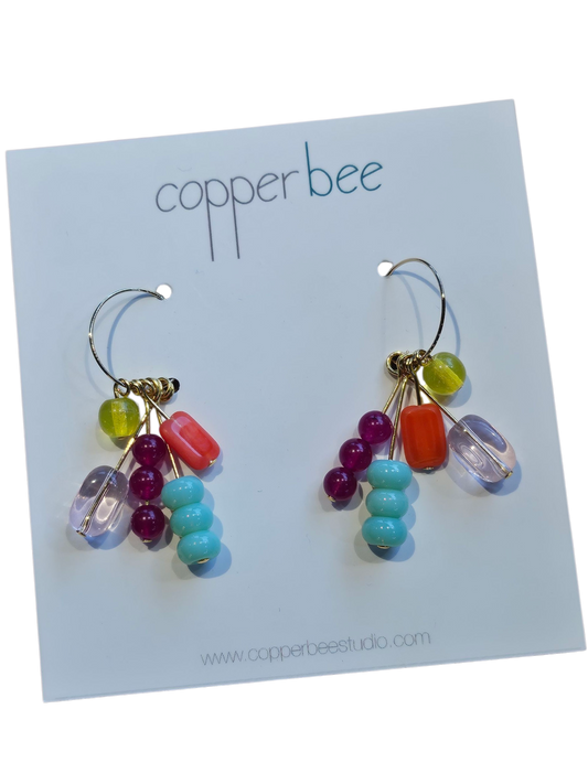 Close-up of Kaleido Array earrings showing assorted vintage, glass, and ceramic beads