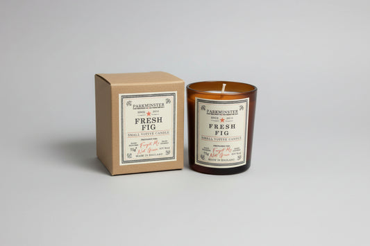 Close-up of Parkminster Fresh Fig Soy Votive Candle in recyclable glass, showing kraft box packaging, vegan home fragrance
