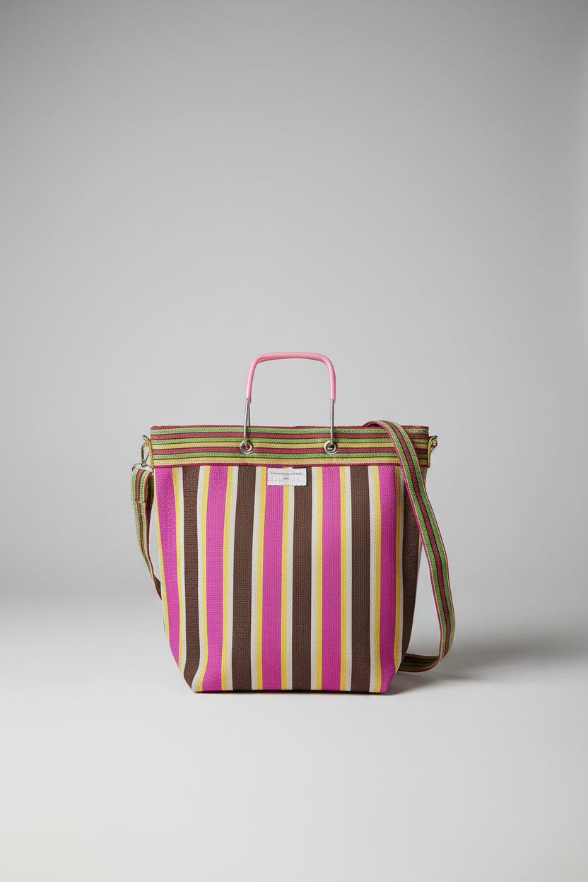 A striped tote bag with horizontal bands of brown, magenta, yellow, with a metal handle and shoulder strap