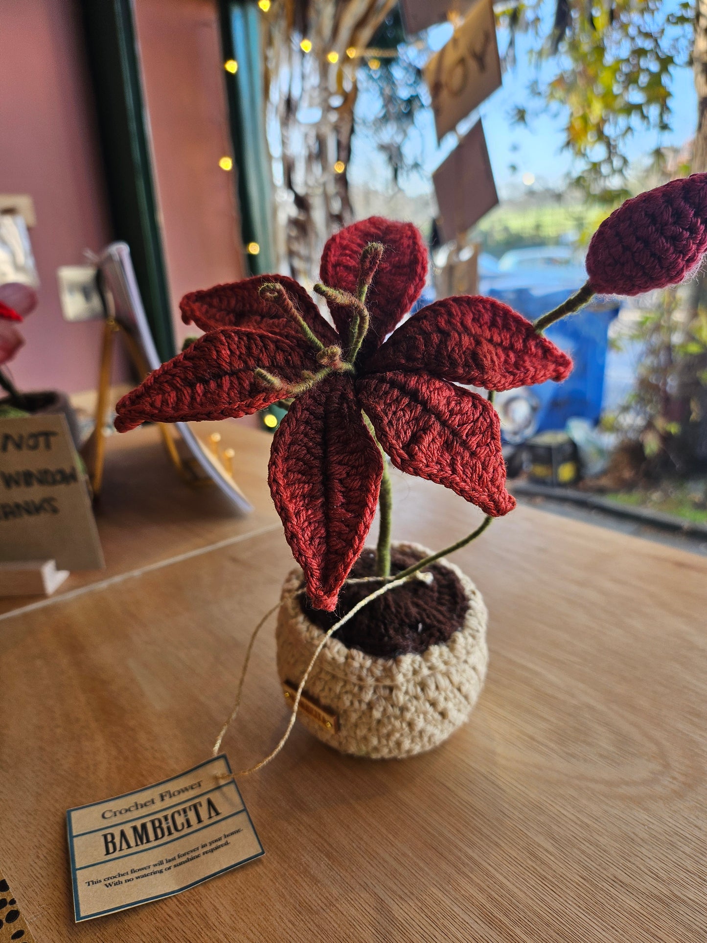 Vibrant handmade crochet flower in a small pot