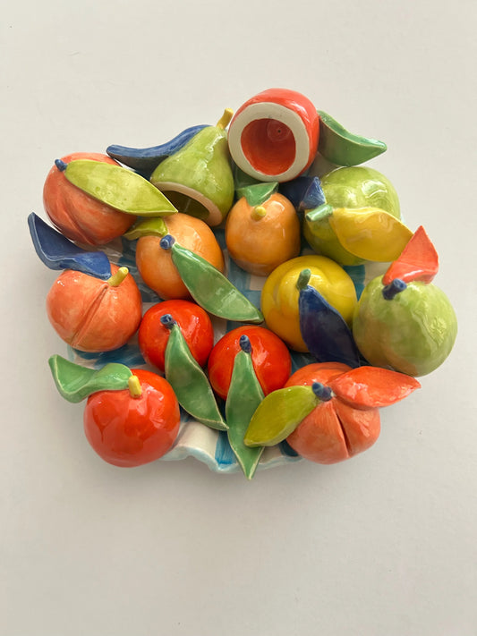Mini Fruit-Shaped Ceramic Candle Snuffers. Shown in a fruit bowl.